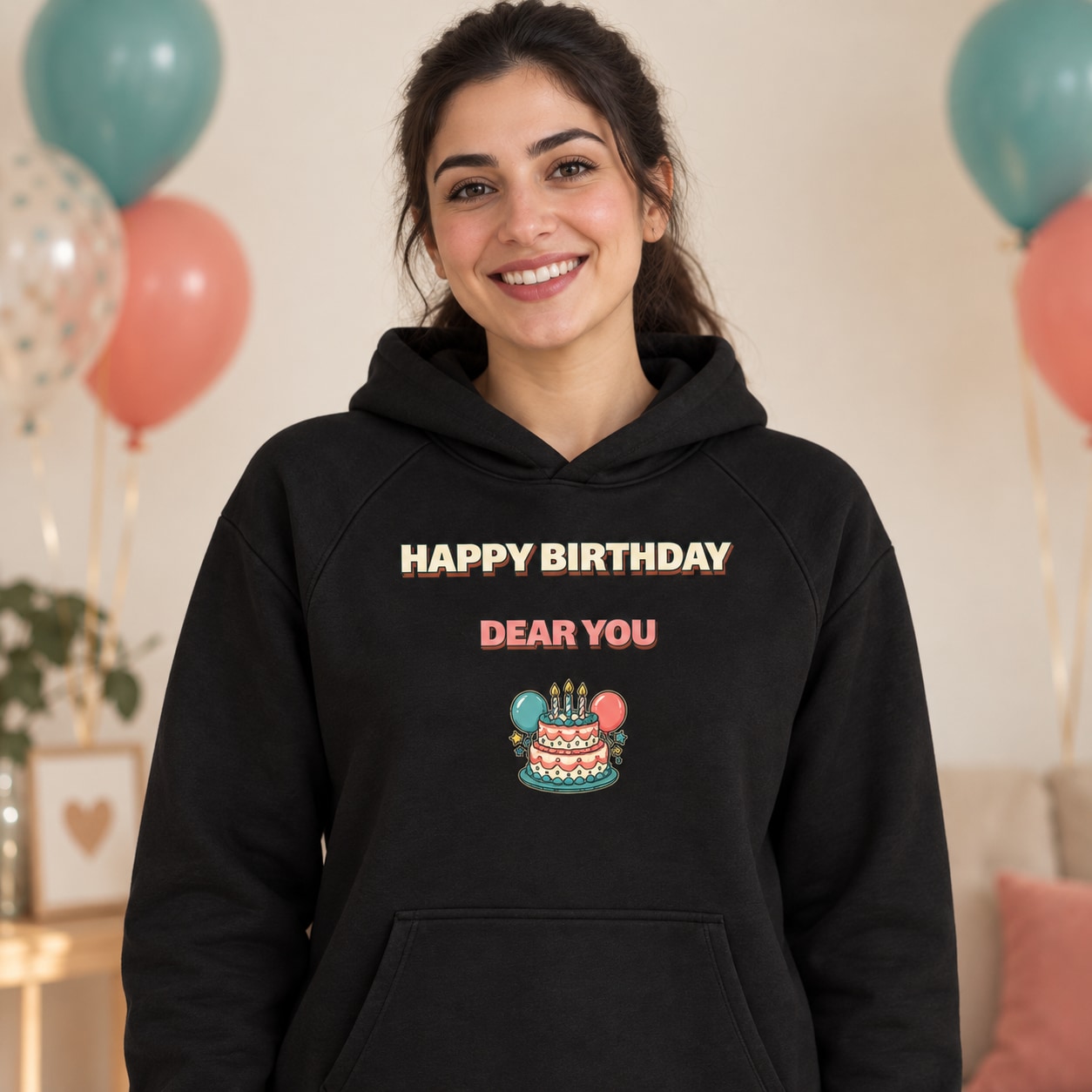 Black hoodie large Happy Birthday and Dear You lettering above a cake and balloons