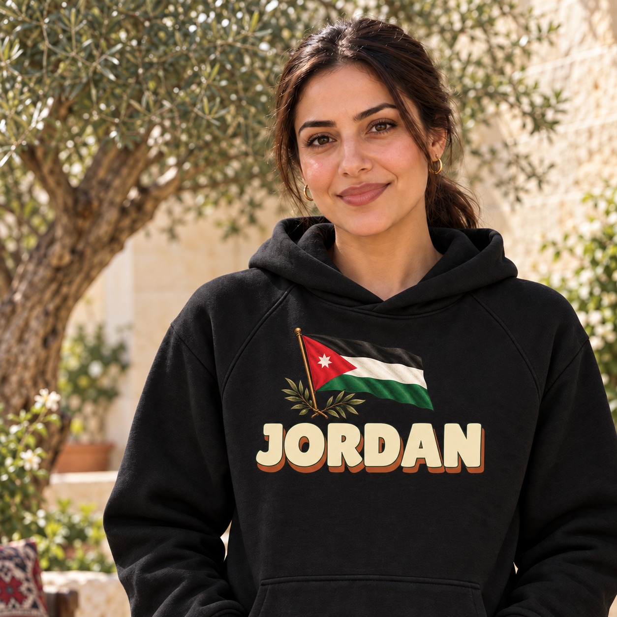 Black hoodie a Jordanian flag with its seven-point star and olive sprigs above large ivory Jordan lettering with a warm solid shadow