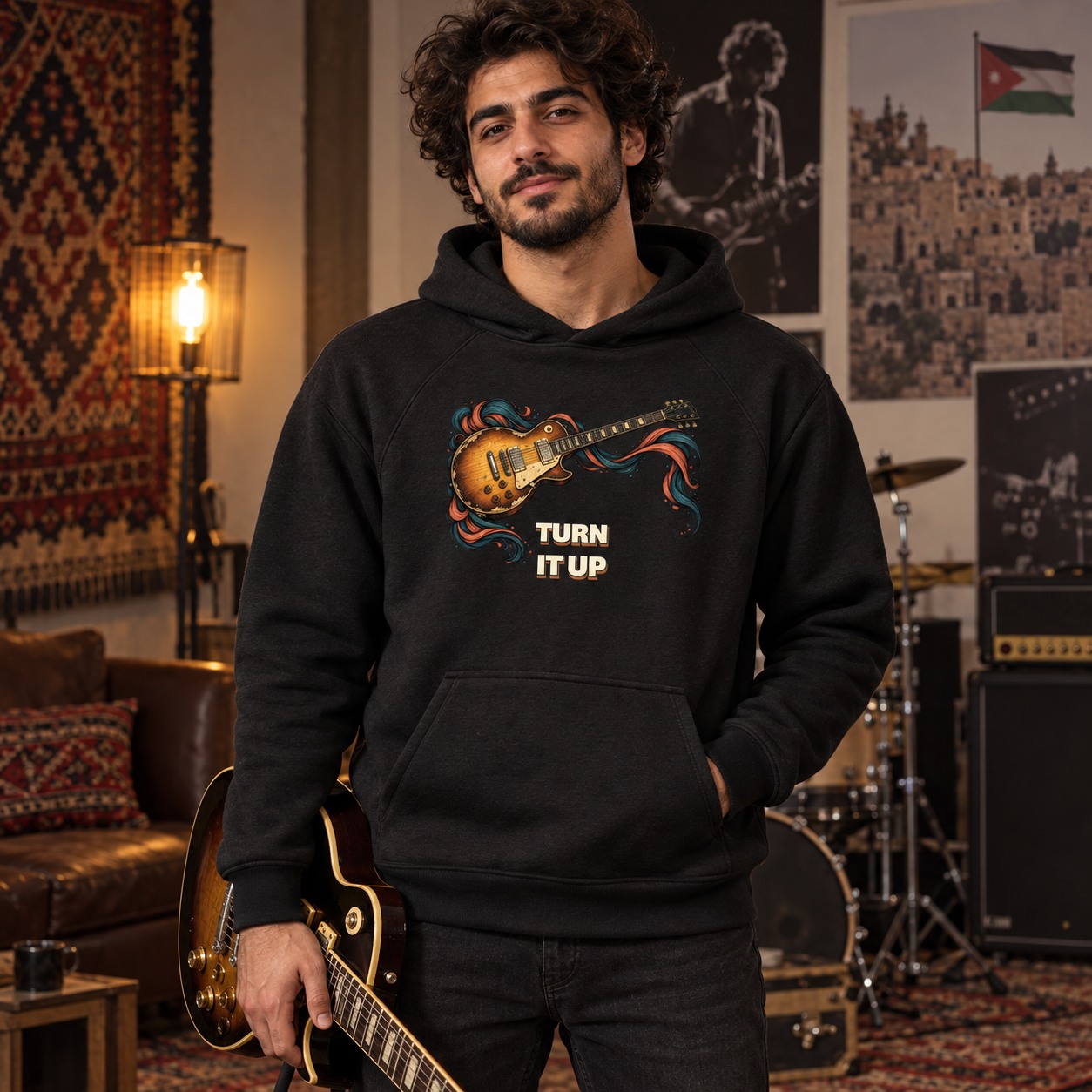 Black hoodie an amber electric guitar with teal and coral sound ribbons